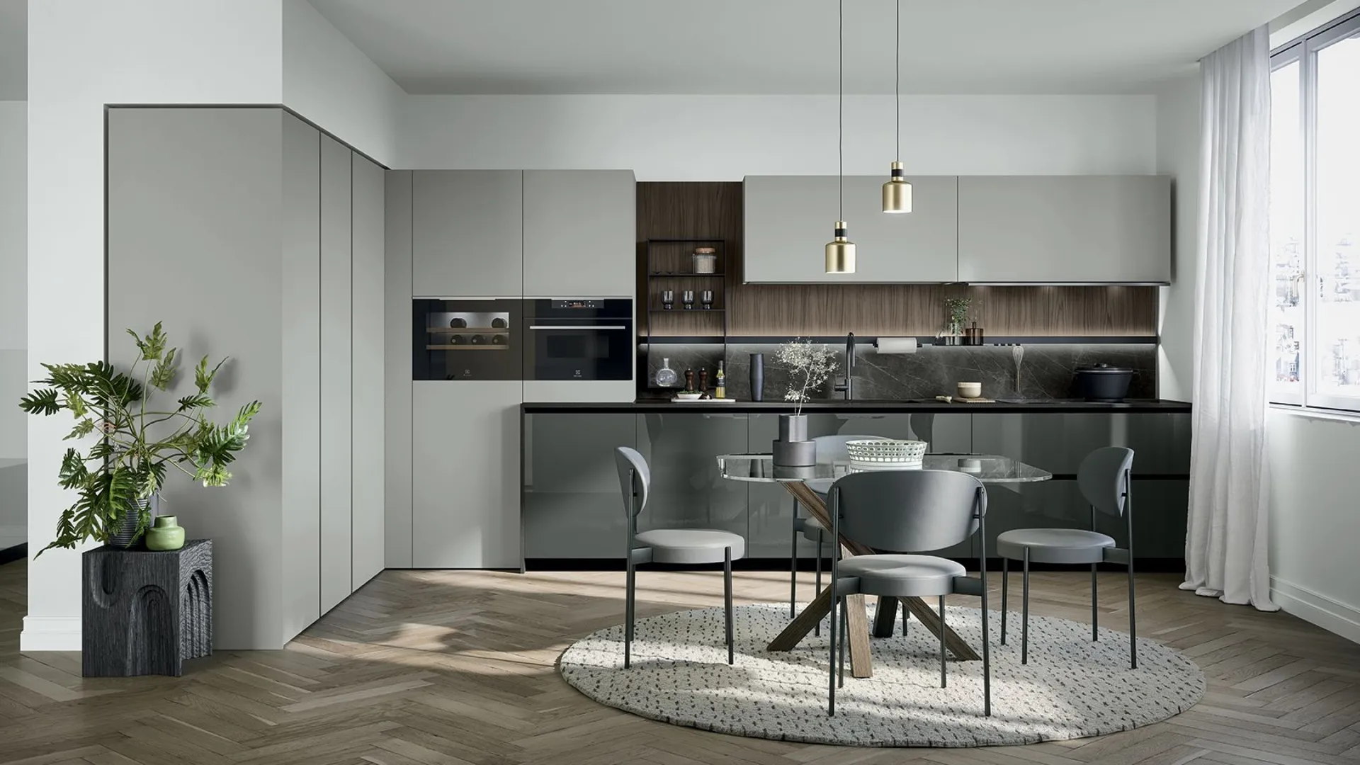 Cucina ad angolo grigia con tavolo rotondo